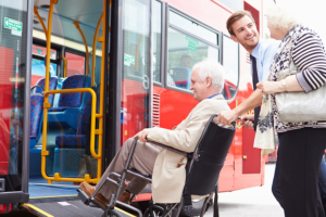 man assisting elderly man on a wheelchair